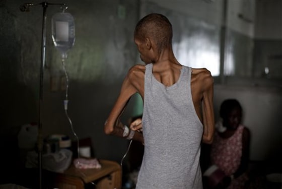A patient stands as he adjusts his intravenous line at the State University Hospital in Port-au-Prince on Friday. Haiti's most important general care facility is struggling six months after the earthquake.